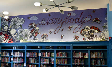 Mural of people flying like ladybugs above bookshelves in school library.