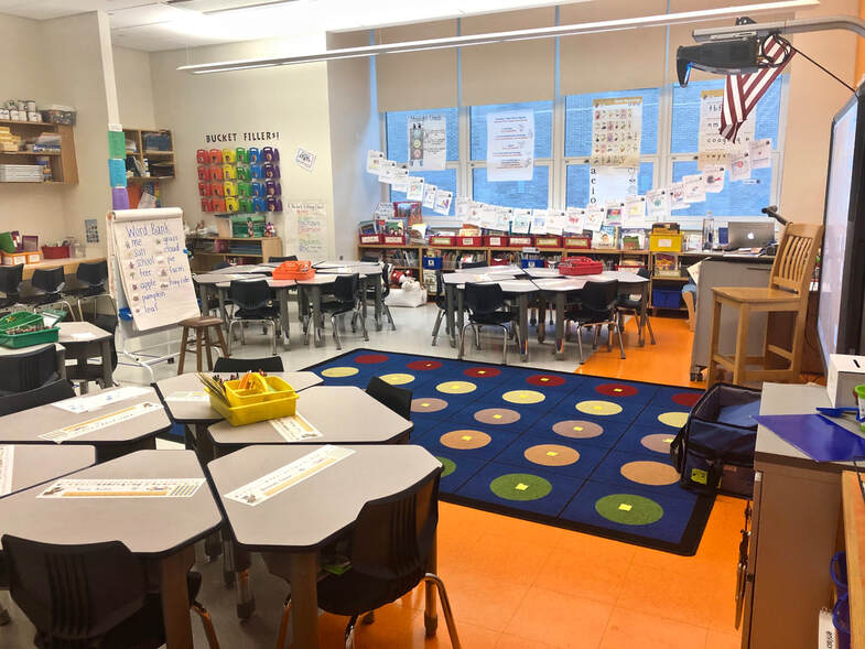 Kindergarten classroom with carpeted meeting area.